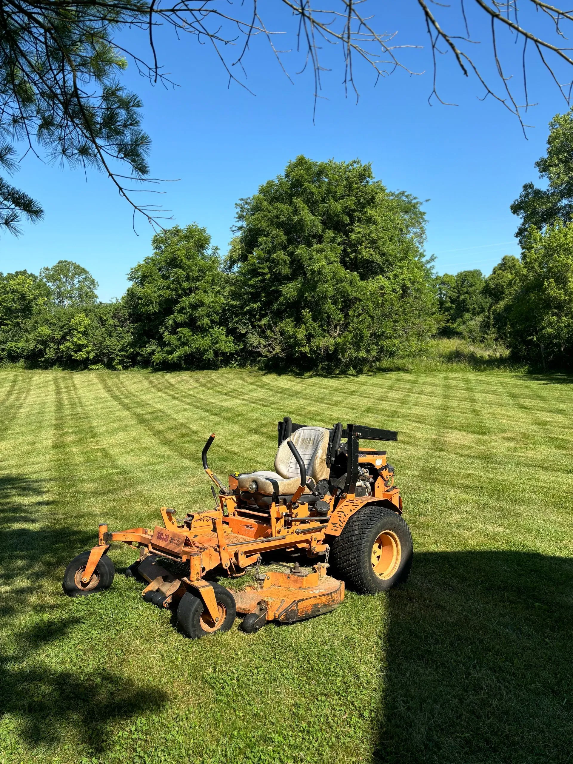 Heavy-duty brush hogging mower clearing an overgrown field